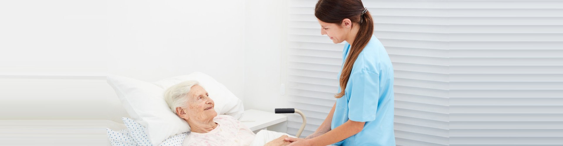 senior woman and female caregiver smiling